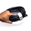 KVNR6808-min - Speedtech International A hand holds a coiled black cable secured with a white SPEEDWRAP® High Temp Cinch Strap, against a white background.